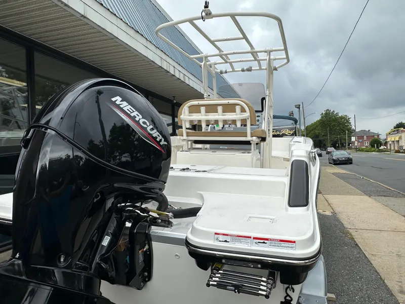 Slide: The Image of 2024 Bayliner Trophy T20CC boat with Mercury outboard motor, parked on street. - 3