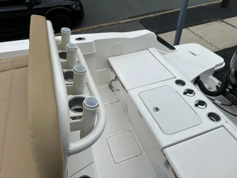 Slide: The Image of 2024 Bayliner Trophy T20CC boat interior with rod holders and seating. - 4