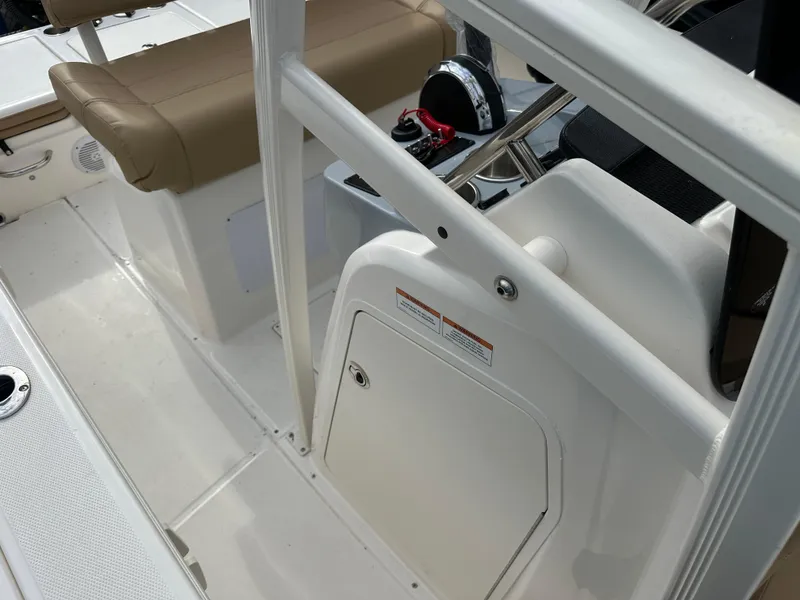 Slide: The Image of 2024 Bayliner Trophy T20CC boat interior with beige seating and control panel. - 7