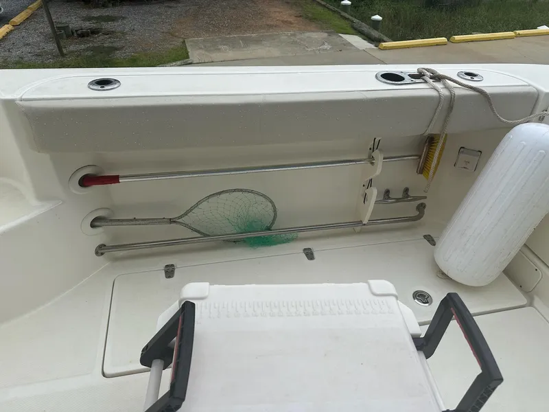 Slide: The Image of 2016 Boston Whaler 315 Conquest deck with fishing net and fender storage. - 10