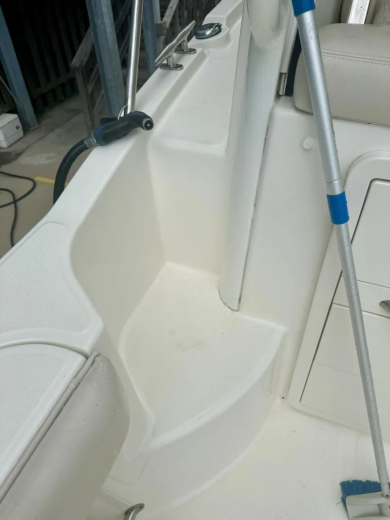 Slide: The Image of Interior view of a 2016 Boston Whaler 315 Conquest boat, featuring seating and storage. - 13