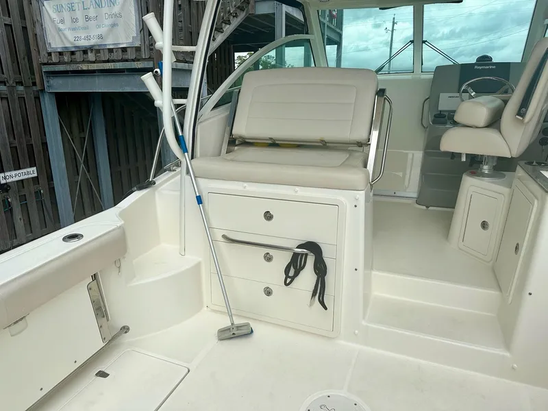 Slide: The Image of 2016 Boston Whaler 315 Conquest interior with seating and storage compartments. - 15