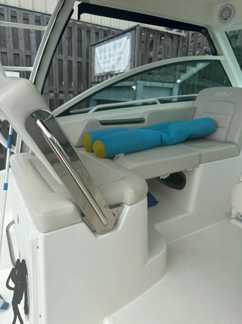 Slide: The Image of Interior of a 2016 Boston Whaler 315 Conquest boat with seating and cushions. - 16