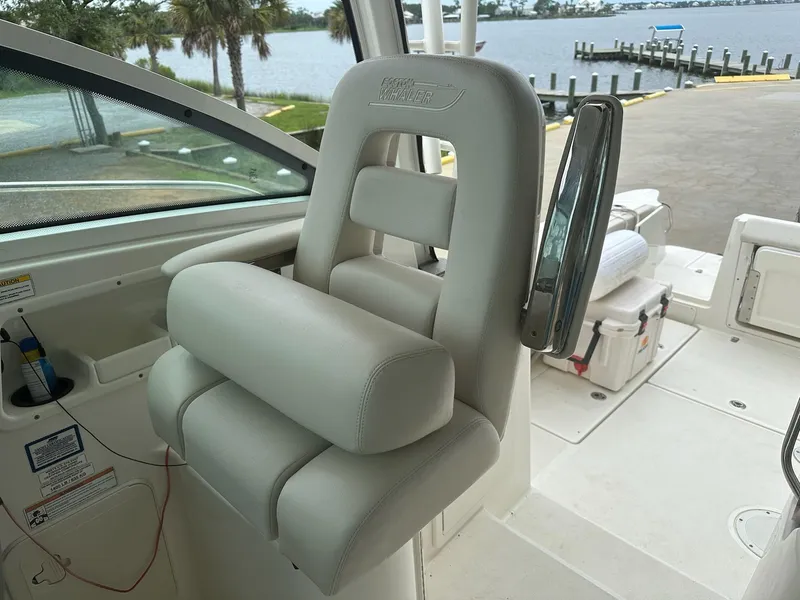Slide: The Image of Captain's chair on 2016 Boston Whaler 315 Conquest boat, dockside view. - 19