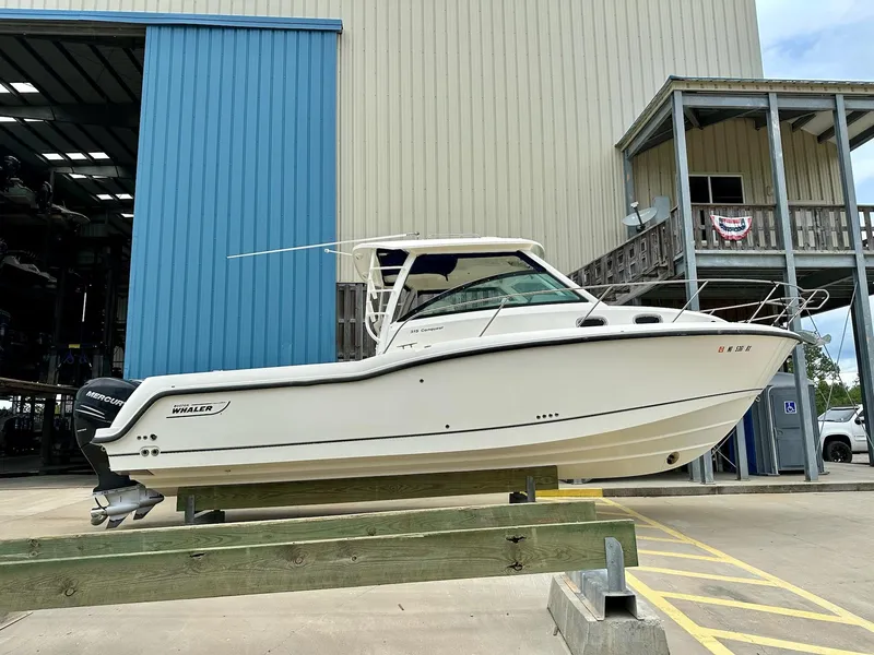 Slide: The Image of 2016 Boston Whaler 315 Conquest boat displayed outside a storage facility. - 2