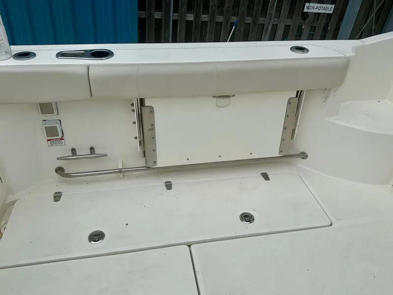 Slide: The Image of 2016 Boston Whaler 315 Conquest boat deck with storage compartments and seating. - 20