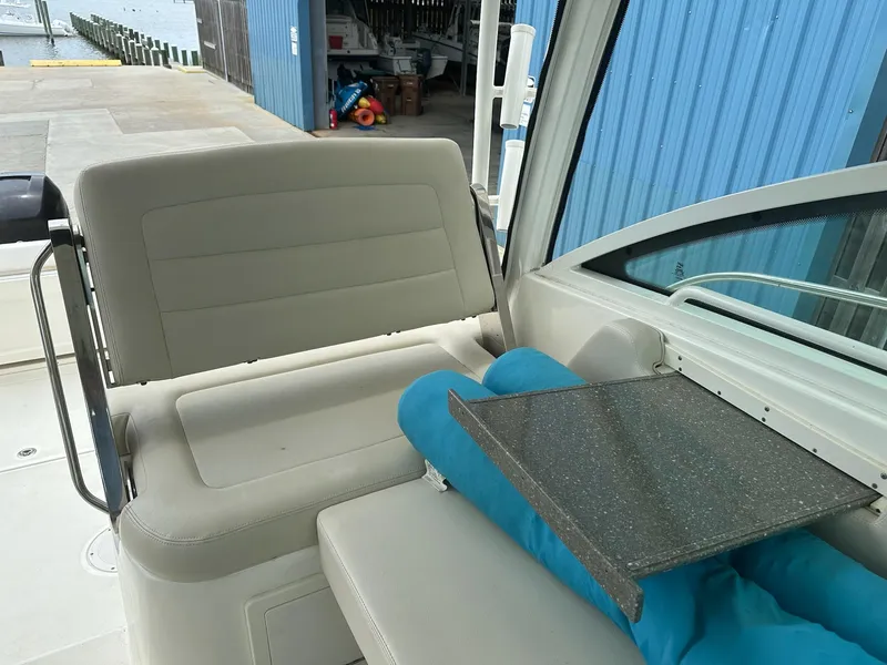Slide: The Image of Interior of 2016 Boston Whaler 315 Conquest boat with seating and table. - 21