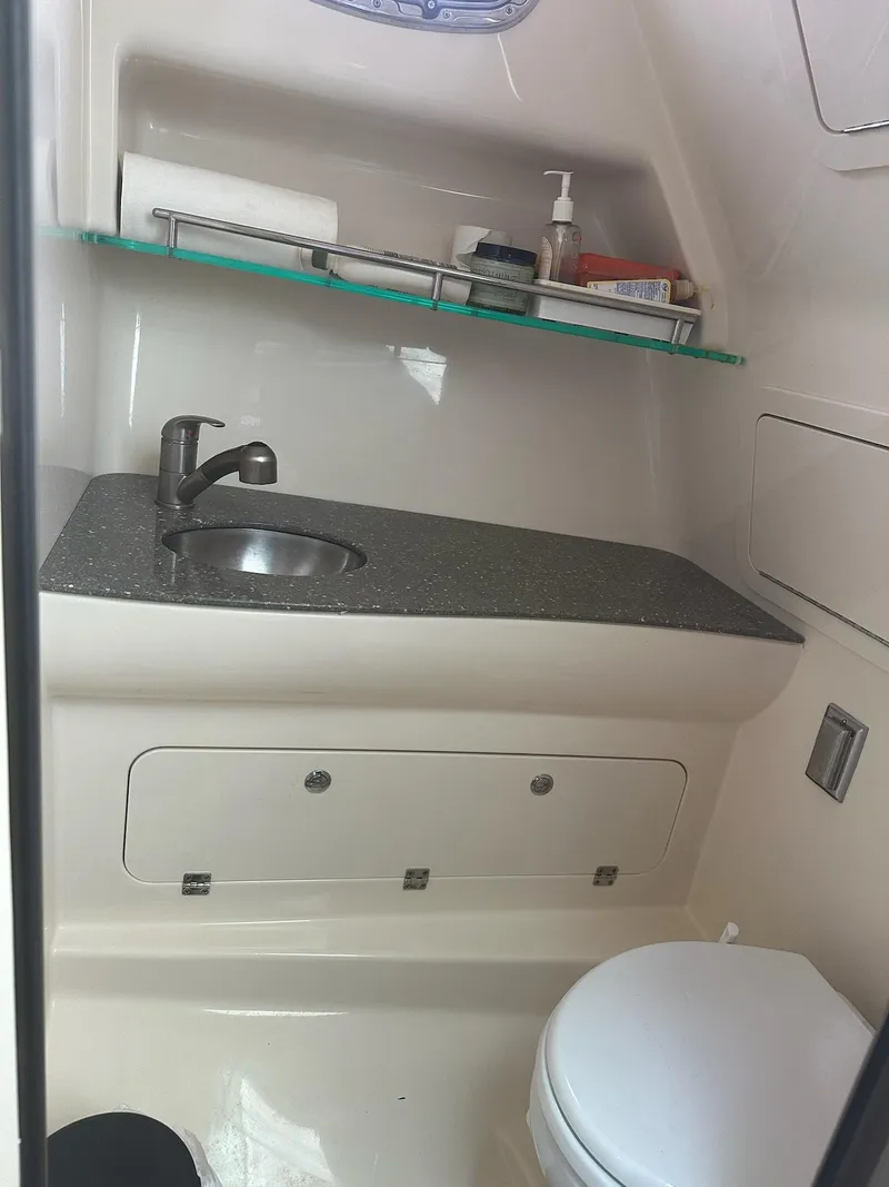 Slide: The Image of 2016 Boston Whaler 315 Conquest bathroom with sink, countertop, and toilet. - 23
