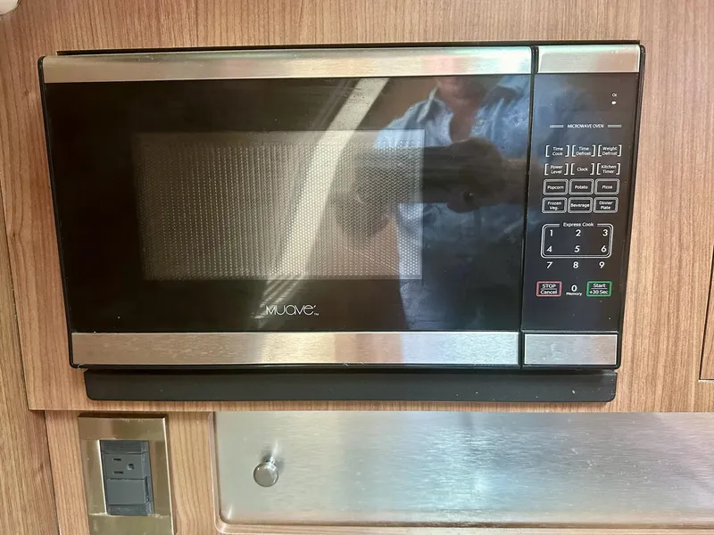 Slide: The Image of Microwave oven inside a 2016 Boston Whaler 315 Conquest boat kitchen area. - 25
