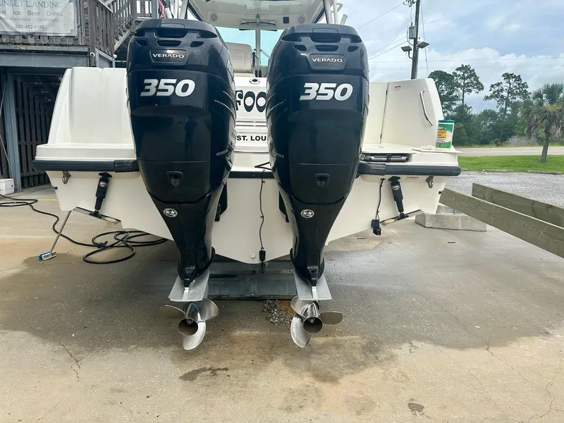 Slide: The Image of 2016 Boston Whaler 315 Conquest with twin 350 Verado engines, docked on concrete. - 4