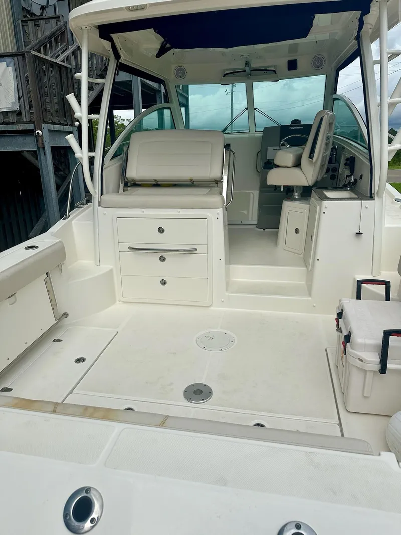 Slide: The Image of 2016 Boston Whaler 315 Conquest boat interior with seating and storage. - 5