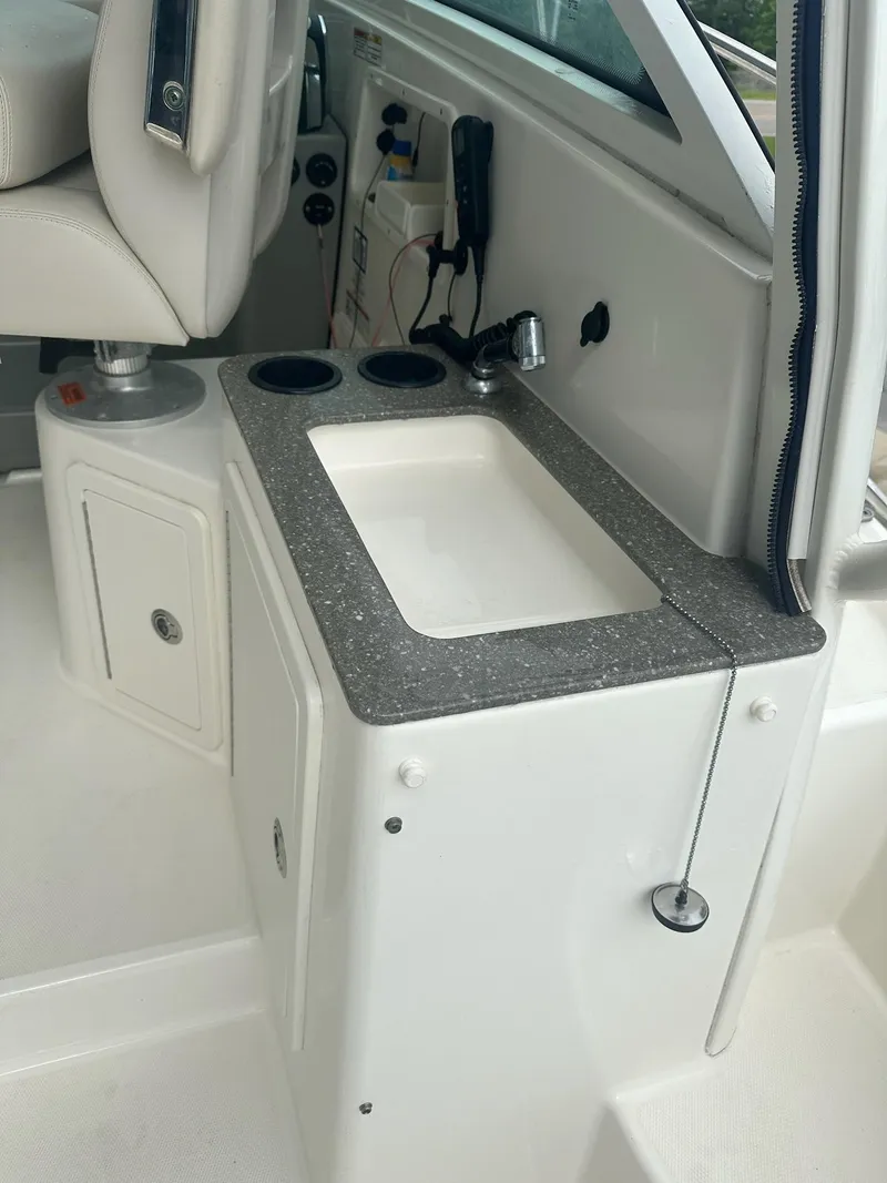 Slide: The Image of 2016 Boston Whaler 315 Conquest interior with sink and storage area. - 8