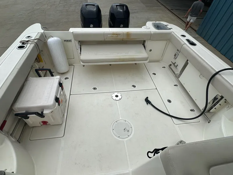 Slide: The Image of 2016 Boston Whaler 315 Conquest boat deck with seating and storage compartments. - 9