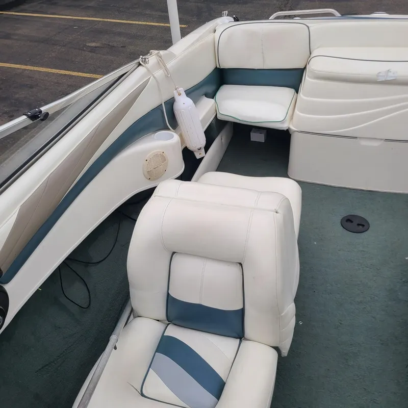 Slide: The Image of 1999 Larson 206 boat interior with white and blue seating. - 9