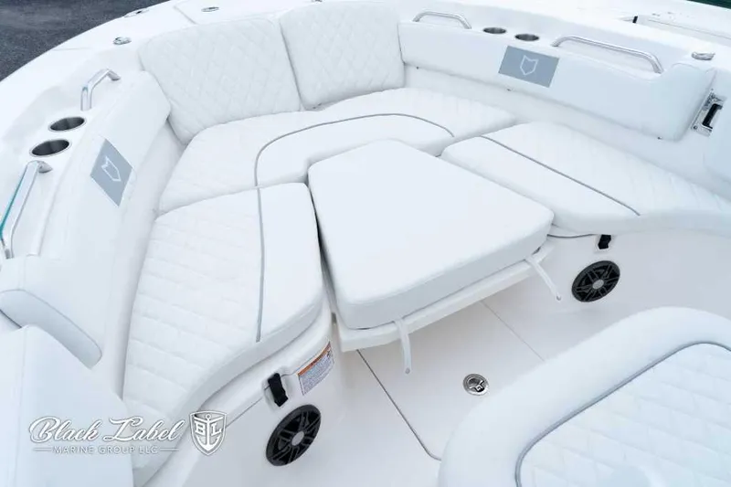 Slide: The Image of 2025 Sea Fox 228 Commander Center Console boat with luxurious white seating and cup holders. - 10