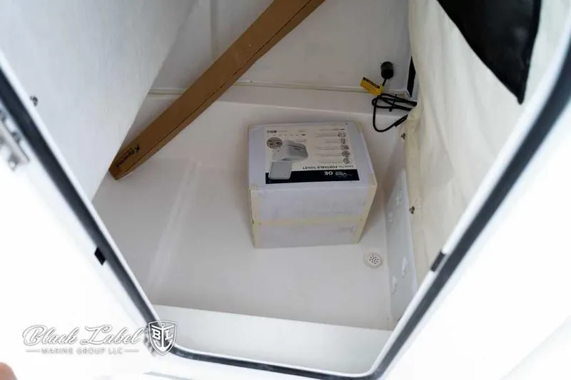 Slide: The Image of 2025 Sea Fox 228 Commander Center Console storage compartment with box and wiring. - 13