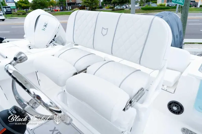 Slide: The Image of 2025 Sea Fox 228 Commander Center Console with luxurious white seating and steering wheel. - 15