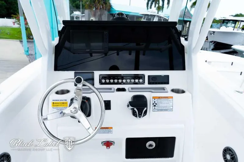 Slide: The Image of 2025 Sea Fox 228 Commander Center Console dashboard with steering wheel and controls. - 16
