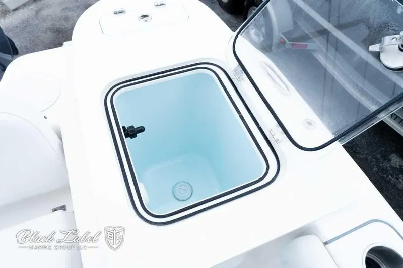 Slide: The Image of 2025 Sea Fox 228 Commander Center Console livewell with open lid, showcasing interior features. - 22