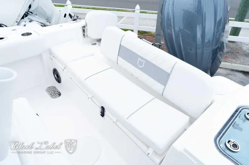 Slide: The Image of 2025 Sea Fox 228 Commander Center Console boat interior with white seating and engine view. - 23