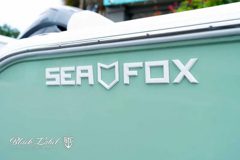Slide: The Image of 2025 Sea Fox 228 Commander Center Console boat logo on mint green hull. - 3