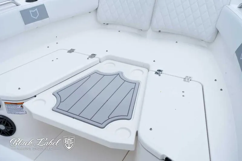 Slide: The Image of 2025 Sea Fox 228 Commander Center Console boat interior with white seating and storage compartments. - 6