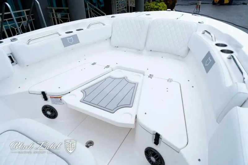 Slide: The Image of 2025 Sea Fox 228 Commander Center Console, white seating area with cup holders and speakers. - 7