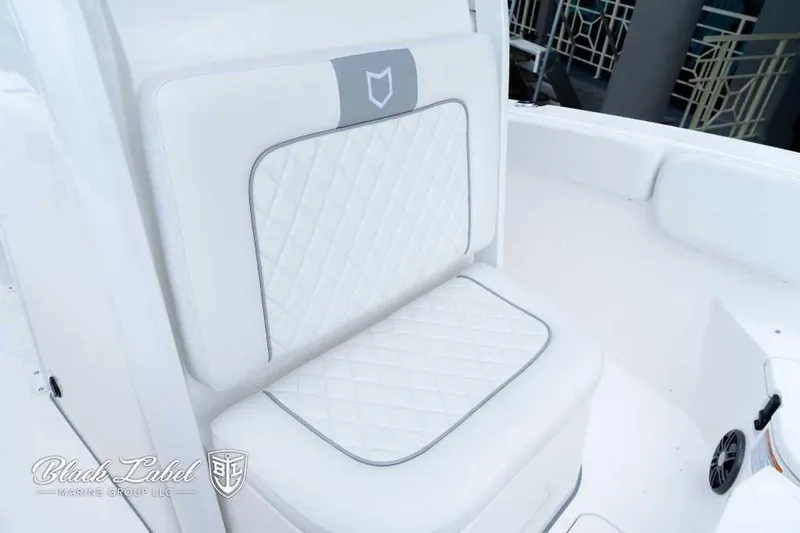 Slide: The Image of 2025 Sea Fox 228 Commander Center Console boat seat with quilted white upholstery. - 9
