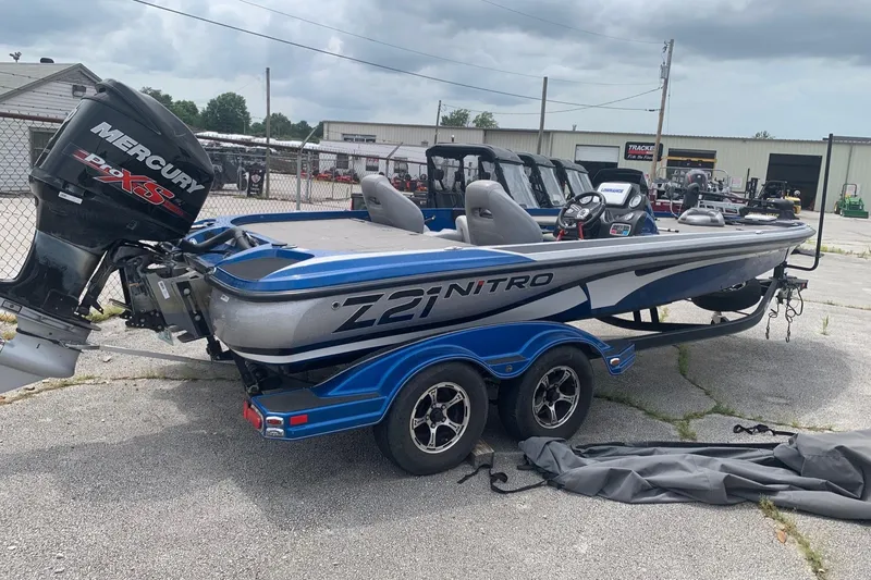 Slide: The Image of 2017 Nitro Z21 Pro boat with Mercury engine on trailer, parked outdoors. - 0