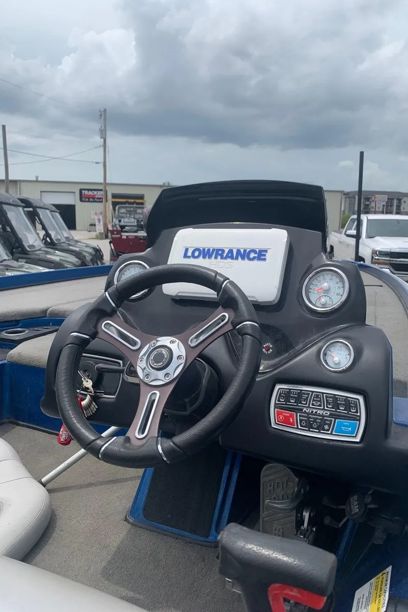 Slide: The Image of 2017 Nitro Z21 Pro boat dashboard with Lowrance electronics and steering wheel. - 1