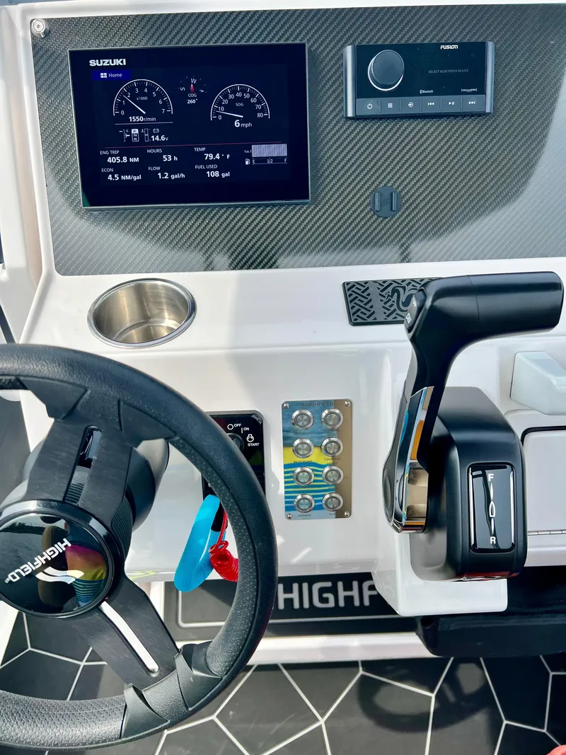 Slide: The Image of 2024 Highfield SP 600 RIB dashboard with steering wheel, controls, and digital display. - 13