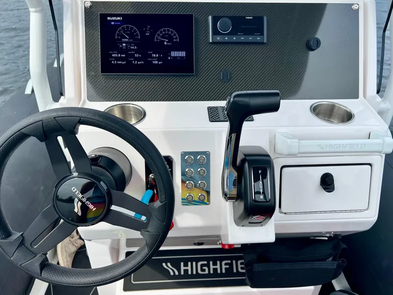 Slide: The Image of 2024 Highfield SP 600 RIB dashboard with steering wheel and control panel. - 14