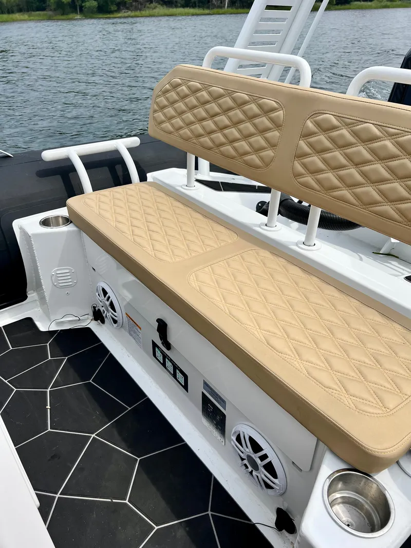 Slide: The Image of 2024 Highfield SP 600 RIB boat interior with tan quilted seating and black flooring. - 15