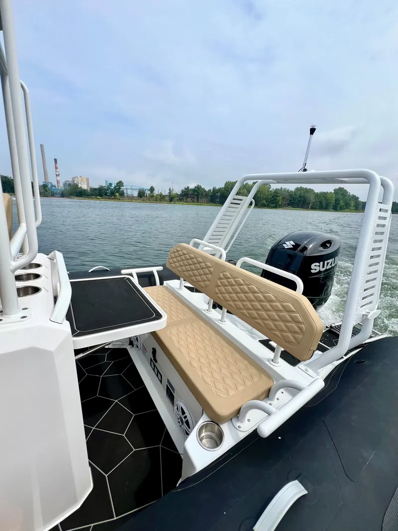 Slide: The Image of 2024 Highfield SP 600 RIB with Suzuki engine on a calm lake. - 18