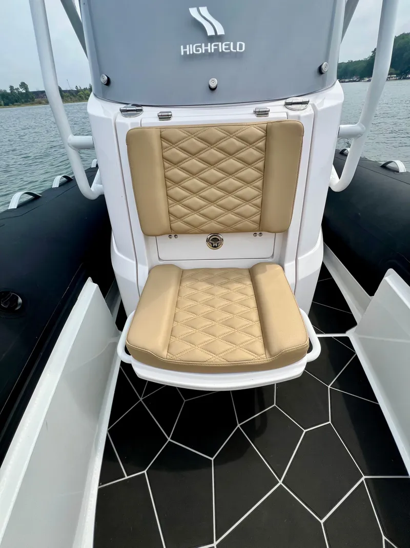 Slide: The Image of 2024 Highfield SP 600 RIB with tan quilted seating and sleek black flooring. - 21