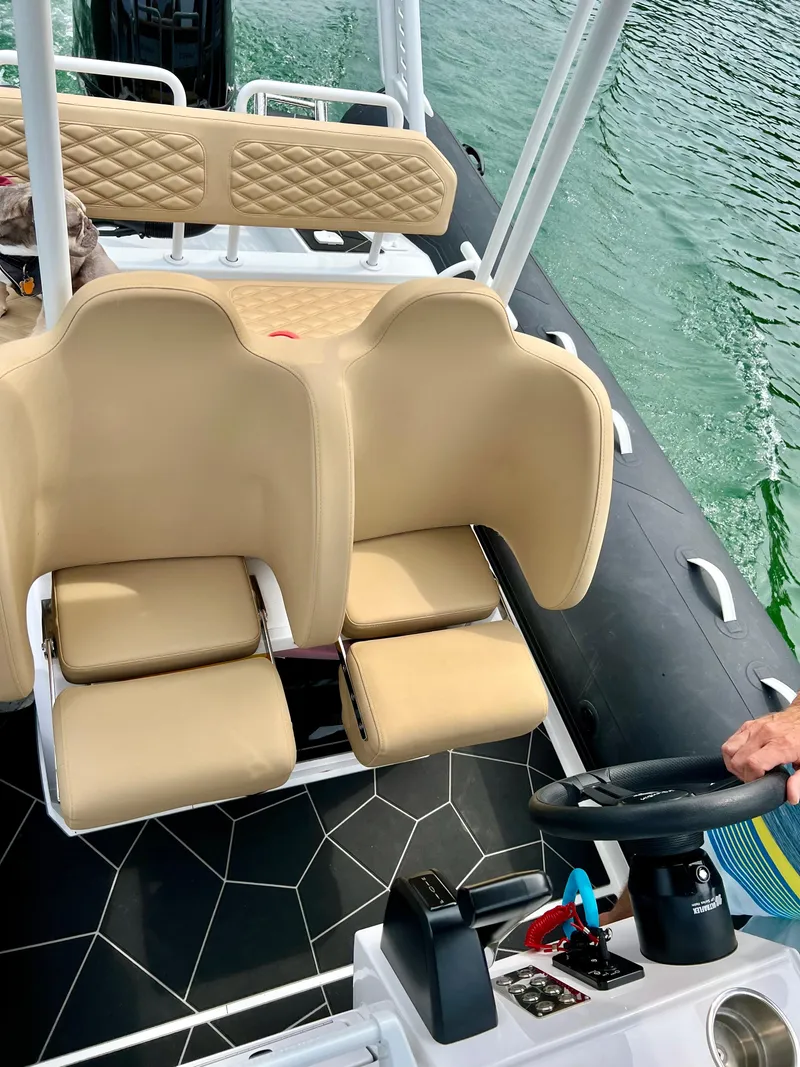 Slide: The Image of 2024 Highfield SP 600 RIB interior with beige seating and steering wheel on water. - 26