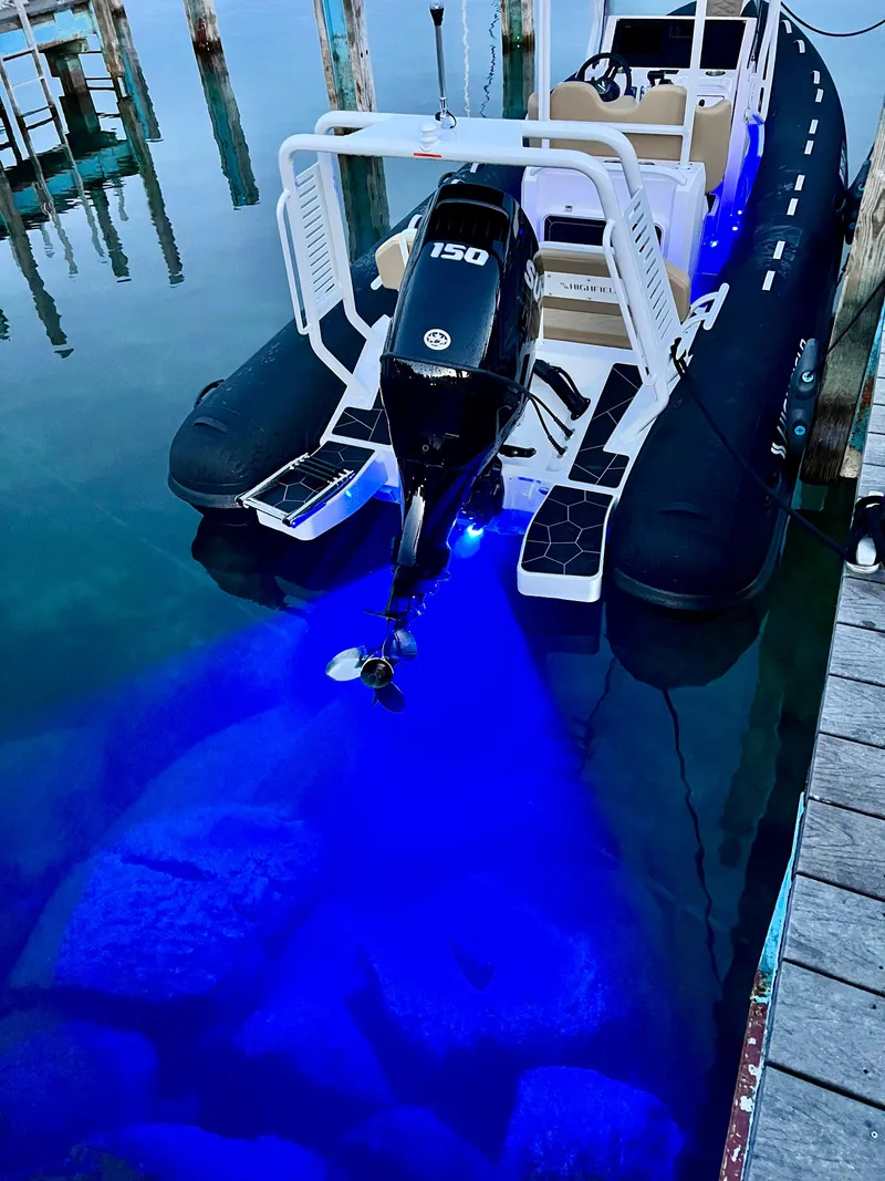 Slide: The Image of 2024 Highfield SP 600 RIB with blue underwater lights at dock. - 3
