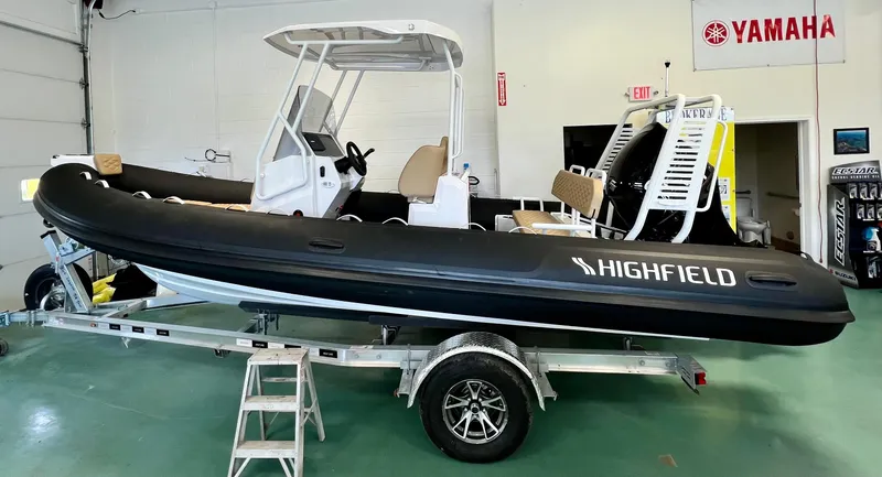 Slide: The Image of 2024 Highfield SP 600 RIB boat on trailer in showroom with Yamaha signage. - 4