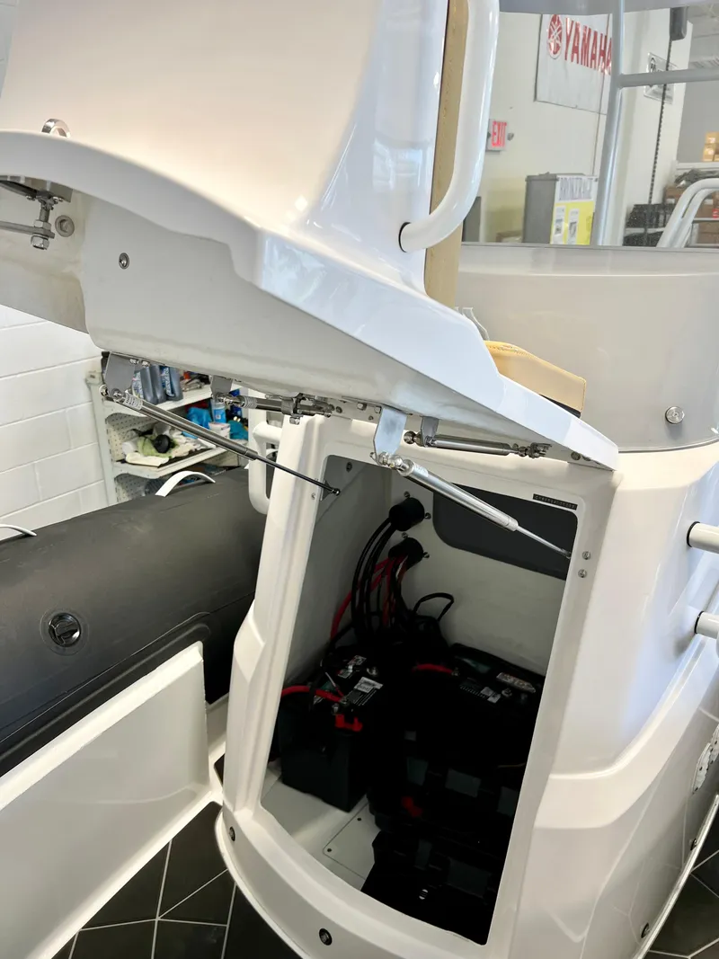 Slide: The Image of 2024 Highfield SP 600 RIB showing open storage compartment with visible wiring and equipment. - 9