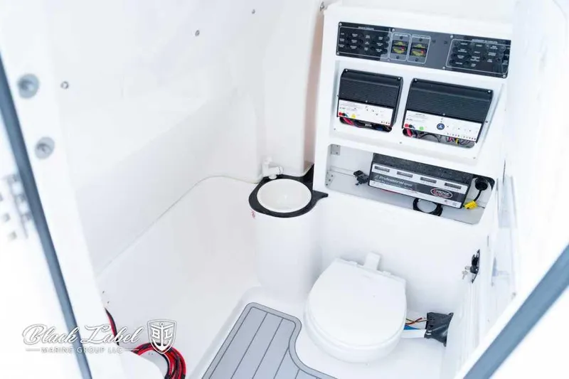 Slide: The Image of 2025 Sea Fox 288 Commander Center Console interior with toilet and control panels. - 14