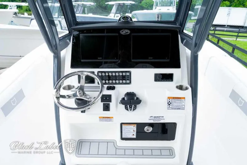 Slide: The Image of 2025 Sea Fox 288 Commander Center Console dashboard with steering wheel and controls. - 19