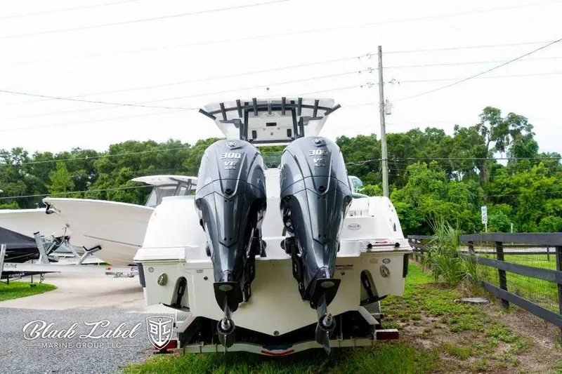 Slide: The Image of 2025 Sea Fox 288 Commander Center Console with twin 300 HP engines, rear view. - 2