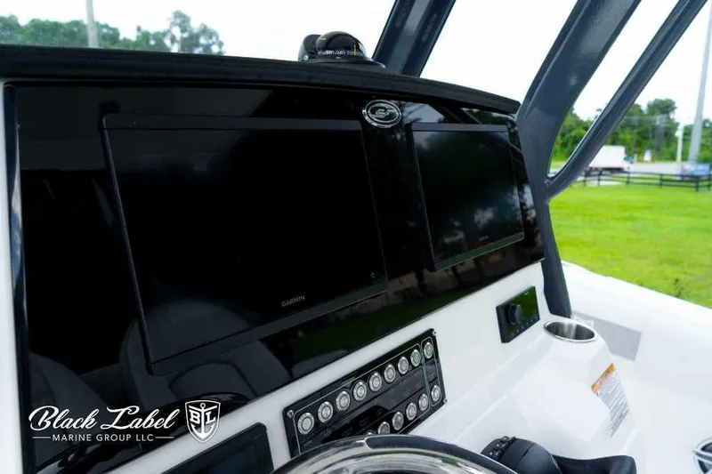 Slide: The Image of 2025 Sea Fox 288 Commander Center Console dashboard with Garmin displays and controls. - 20