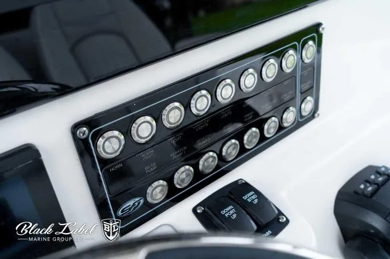 Slide: The Image of 2025 Sea Fox 288 Commander Center Console dashboard with control panel and switches. - 22