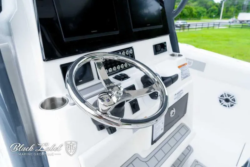Slide: The Image of 2025 Sea Fox 288 Commander Center Console helm with modern controls and steering wheel. - 24