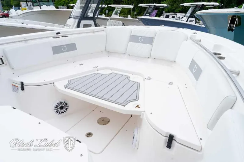 Slide: The Image of 2025 Sea Fox 288 Commander Center Console boat interior with white seating and deck. - 7