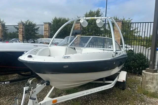 Slide: The Image of 2010 Bayliner 185 Flight boat on trailer, parked outdoors. - 0