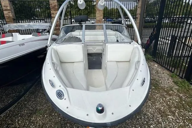 Slide: The Image of 2010 Bayliner 185 Flight boat with white interior, parked outdoors. - 2