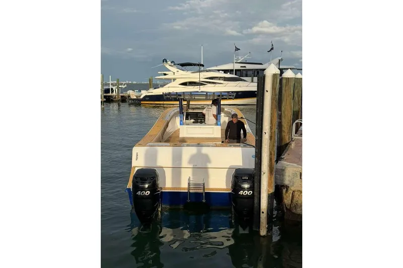 Slide: The Image of 2024 Custom Catamaran SET CAT docked with dual 400 engines, sunny day. - 10