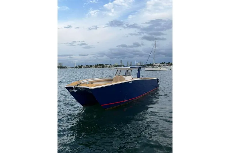 Slide: The Image of Custom 2024 Catamaran SET CAT on water, with city skyline in background. - 103